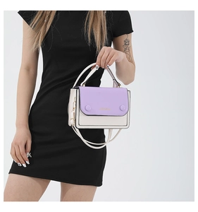 Close-up of contrast color crossbody bag with purple flap and cream white body