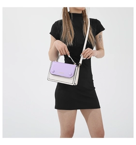 Detail of a two-tone square crossbody bag showing matte PU leather and black oil edges