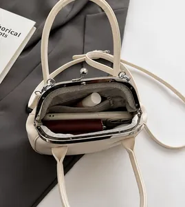 Interior view of white shell bag showing spacious capacity for phone and wallet