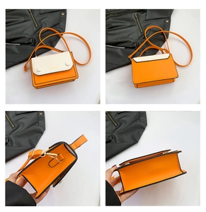 Detail view of contrast color stitching small square bag with adjustable shoulder strap