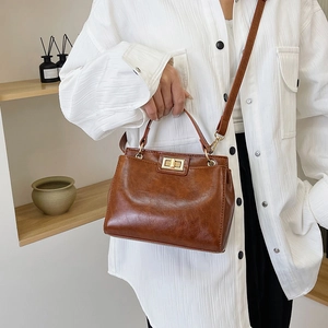 Vintage dark brown glossy leather handbag with golden square lock and shoulder strap