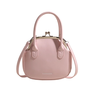 Pink minimalist shell-shaped handbag with top handle and crossbody strap for women