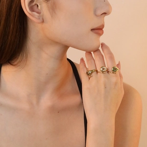 Set of 3 18K gold plated open rings with black, white, and green crystals on hand