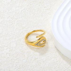 Detailed view of teardrop emerald-cut stone and crystals on 18K gold plated ring