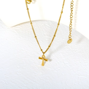 Polished gold Ankh cross pendant necklace with beaded bobbi chain on white display stand