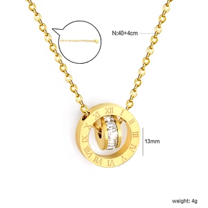 Macro detail of a 13mm gold double ring pendant featuring roman numerals and clear crystals