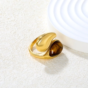 Detailed macro view of the gold teardrop ring featuring a natural tiger eye stone