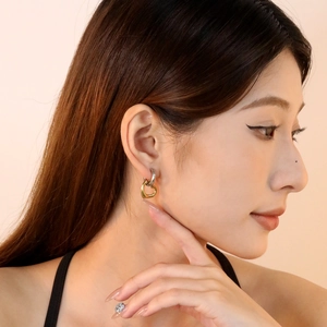 Two-tone heart-shaped interlocking drop earrings in polished gold and silver steel finish