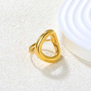 Polished gold adjustable geometric ring with triangle cutout on a minimalist white surface