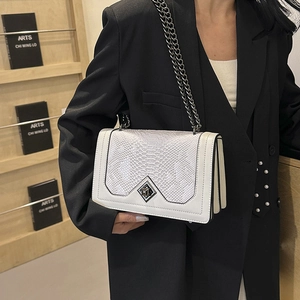 White faux crocodile skin crossbody bag with silver chain and metal clasp