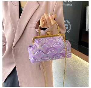 Close-up of purple sequin lace evening bag with gold metal handle and chain strap