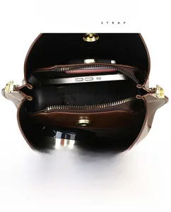 Internal view of the brown bucket bag showing large capacity and multi-layer pockets