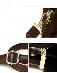 Detailed view of dark brown leather bucket bag featuring shiny gold-tone hardware and zippers