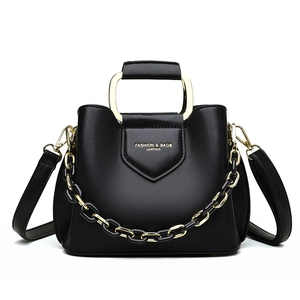 Elegant black leather bucket bag with gold square handle and chunky chain strap