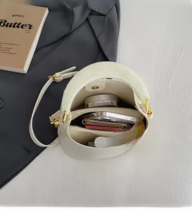Vue de dessus du sac seau blanc montrant l'espace pour téléphone, portefeuille et maquillage