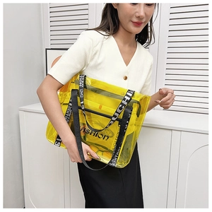 Detail of transparent yellow PVC tote bag with black fashion straps and inner pouch