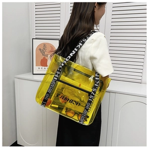 Detail of yellow transparent PVC tote bag with street style letter printed shoulder strap