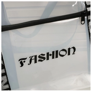 Detailed close-up of transparent PVC tote bag with black gothic FASHION print and zipper