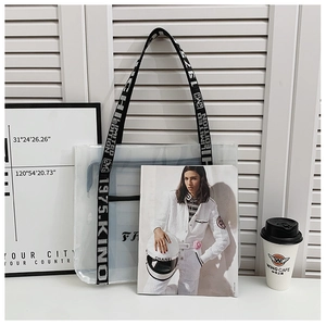 Detail of transparent PVC tote bag with black and white woven 'Limited Edition' strap