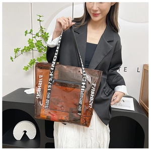 Brown transparent PVC tote bag detail with fashion lettering and branded shoulder strap