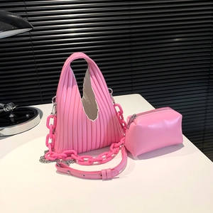 Chic Barbie pink pleated handbag set with resin chain and crossbody strap on desk