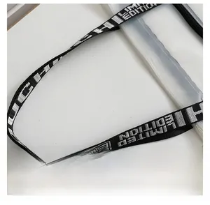 Detail of transparent PVC tote bag with black strap featuring white LIMITED EDITION text