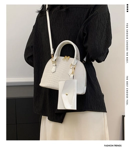 Detail of white crocodile pattern shell bag with small matching card holder and gold hardware