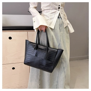 Detail of black crocodile texture tote bag made of high-quality faux leather for commute