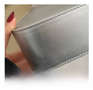 Close-up of high-quality silver leather bag showing precise stitching details on the bottom