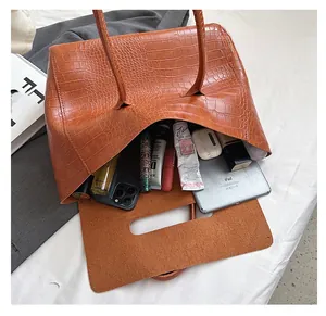 Interior view of large caramel crocodile-pattern tote bag showing ample storage space