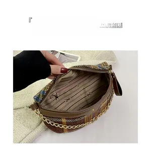 Detail view of plaid tweed bag interior with chain strap and spacious compartments