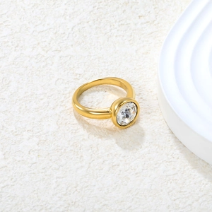 Detail of 18k gold plated stainless steel ring with bezel-set round cubic zirconia