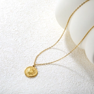 Minimalist gold sun medallion pendant necklace in vintage stainless steel finish