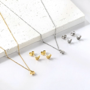 Elegant butterfly jewelry set with gold and silver necklaces and matching stud earrings