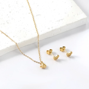 Elegant 18K gold butterfly jewelry set featuring a pendant necklace and stud earrings