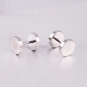 Macro detail of silver dumbbell stud earrings with flat disk design in stainless steel