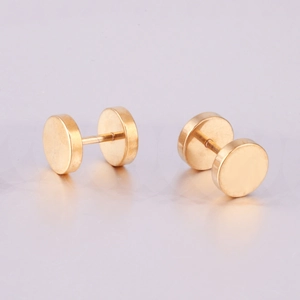 Macro shot of gold dumbbell stud earrings featuring double flat circular discs