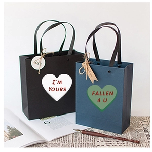 Elegant gift bags with heart stickers 'I'm Yours' and 'Fallen 4 U' in aesthetic setting
