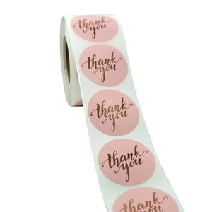 Pink round thank you roll stickers with rose gold metallic script for gift packaging