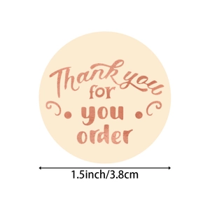 Roll of 1.5 inch beige round thank you for your order stickers with rose gold foil