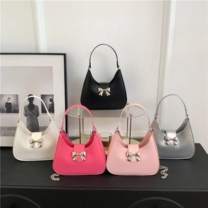Five minimalist solid color hobo bags with golden bow clasps and chain straps