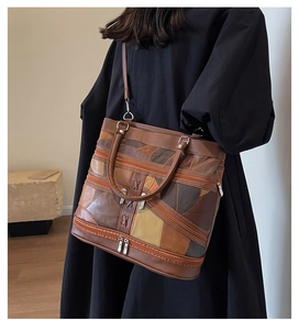 Detail of vintage patchwork leather tote bag with zip pockets and shoulder strap
