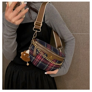 Detail of retro plaid chest bag with golden chain and bear plush pendant decoration