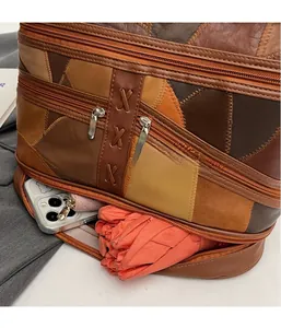 Detail of brown patchwork tote bag with large capacity bottom zipper compartment for storage