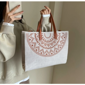 Macro shot of large canvas tote bag with bohemian geometric print and leather handle