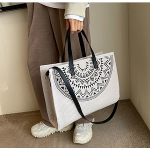 Detail of bohemian tote bag with black geometric print and durable double straps