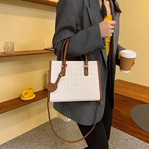 White quilted tote bag with brown trim and heart charm, stylish large capacity shoulder bag
