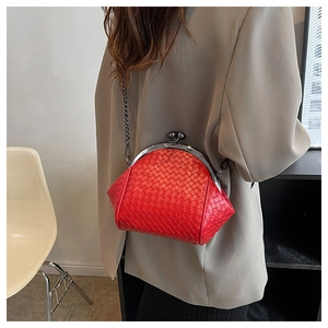 Detail of red woven texture on a retro shell bag with silver metal chain and clasp