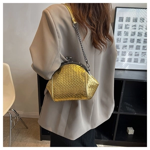 Detail of gold woven chain bag featuring classic metal clasp and premium PU texture