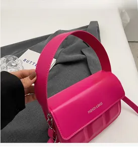 Detail of rose red mini square bag with wide handle and fashion letter print